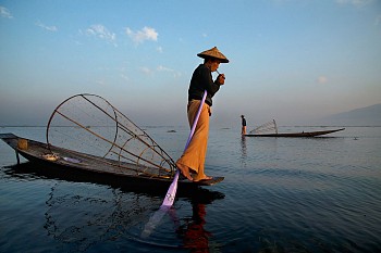 Steve McCurry - Steve McCurry Fisherman Lights Cigarette on Boat
